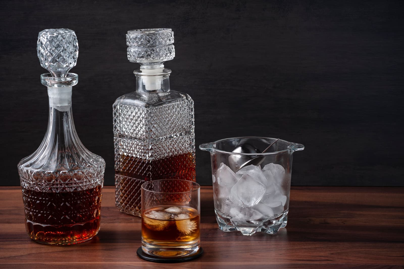 An elegant whiskey setup on dark wood
