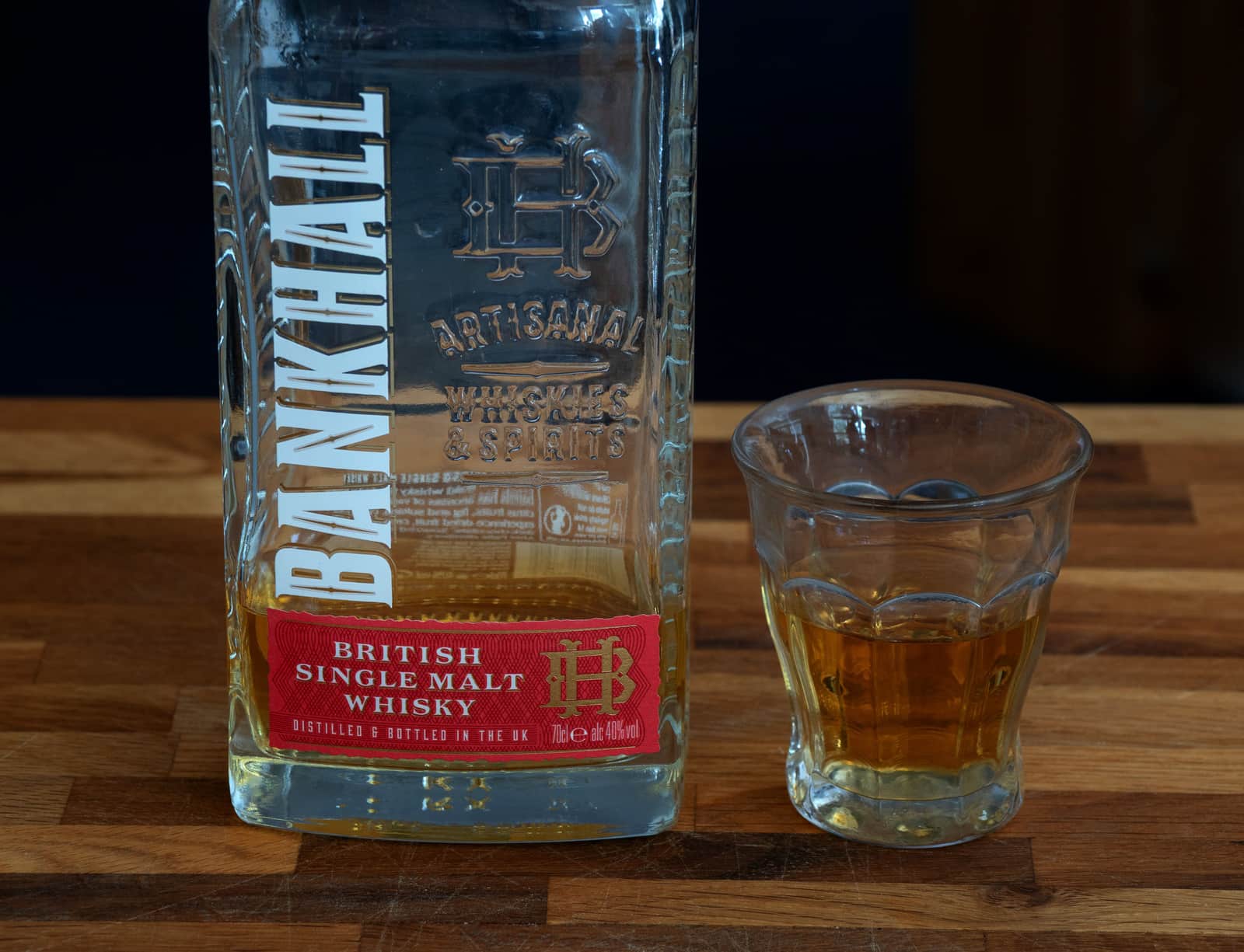 A whiskey glass on a minimal table