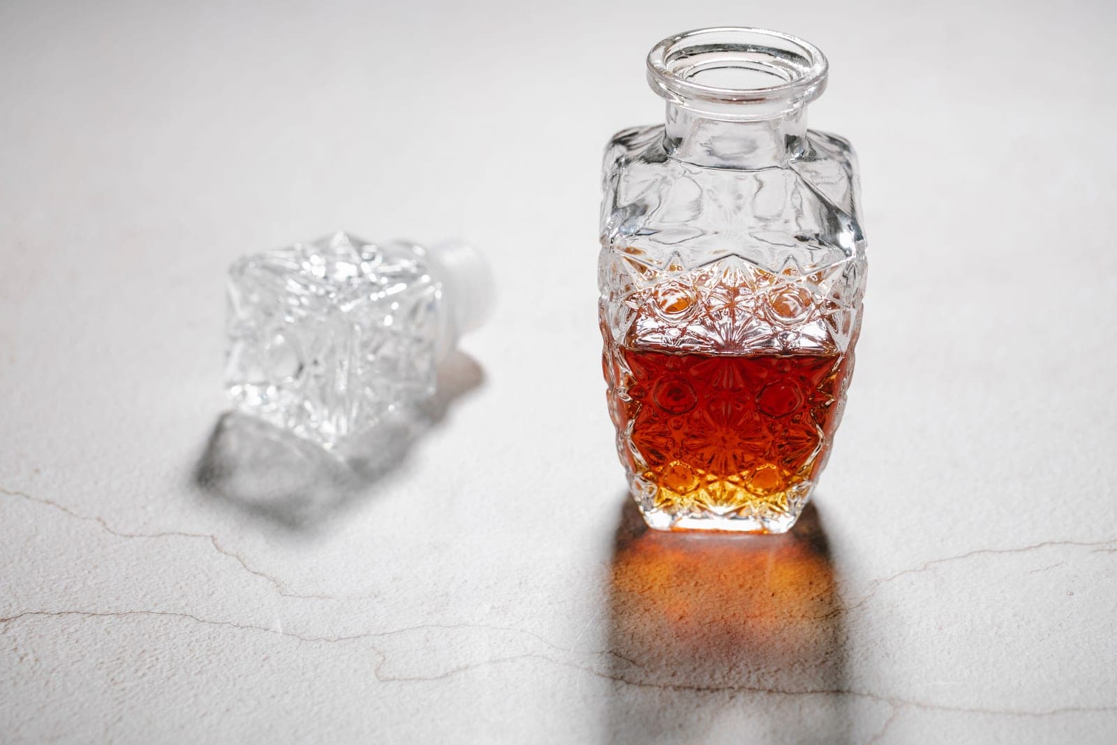A crystal decanter holding amber spirit