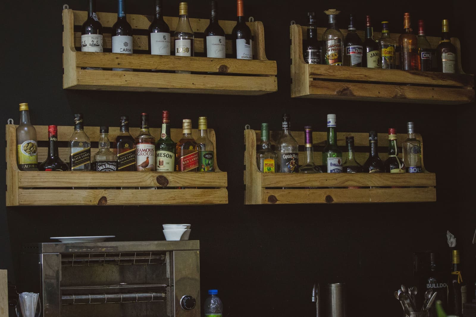 Whiskey bottles on a wooden shelf