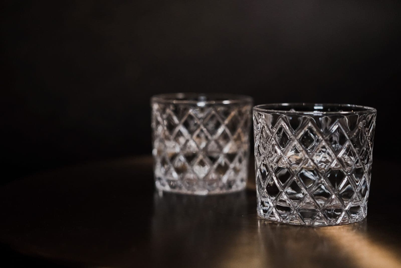 Empty whiskey glasses on a bar counter